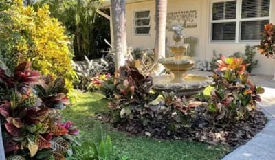 Beautiful garden with fountain and colorful plants