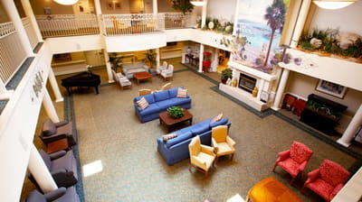 A spacious lobby area with seating and decorative elements.