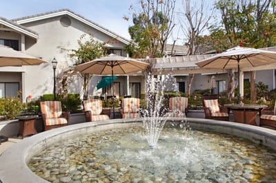 Outdoor space with a fountain and lounge chairs