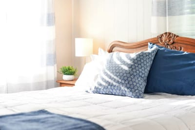 Cozy bedroom with a decorative bed and soft lighting