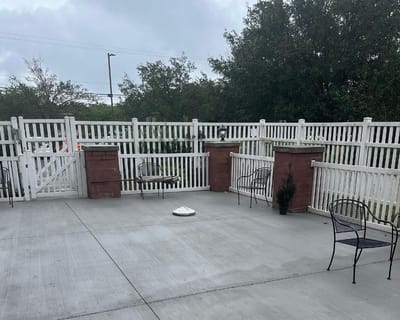 Outdoor patio area with seating and fencing