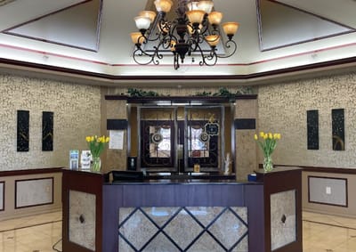 Reception area with chandelier and floral decor