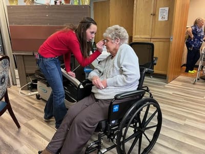 Staff assisting a resident in a common area