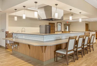 Modern dining area with seating and kitchen equipment