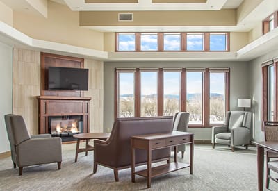 Bright common area with large windows and seating