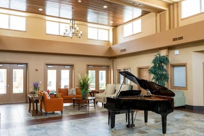 Bright, welcoming lobby with piano and seating
