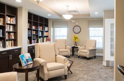 Cozy reading area with bookshelves and comfortable chairs