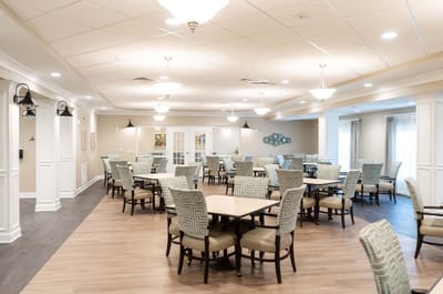 Bright common area with dining tables and chairs