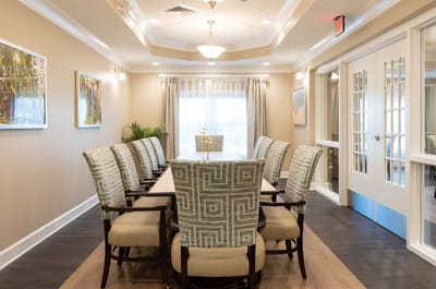 Bright common area with a large dining table and chairs
