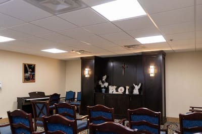 Interior view of a facility's common room with chairs and decor