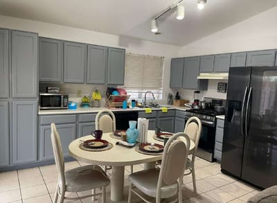 Bright kitchen space with dining table and appliances