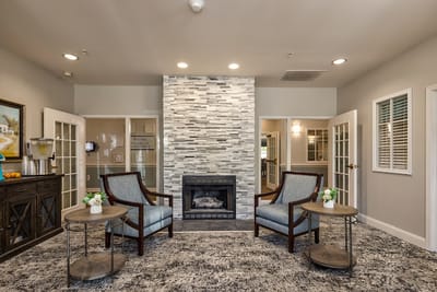 Welcoming common area with seating around a fireplace