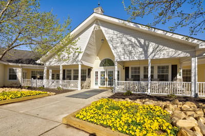 Front entrance of TerraBella Hillsborough with yellow flowers