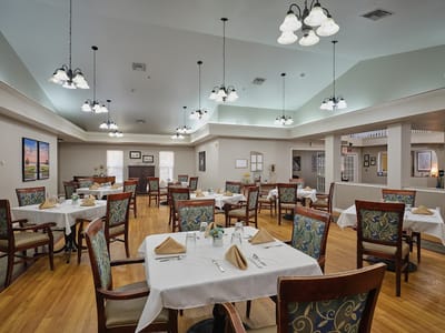Bright dining area with tables set for residents