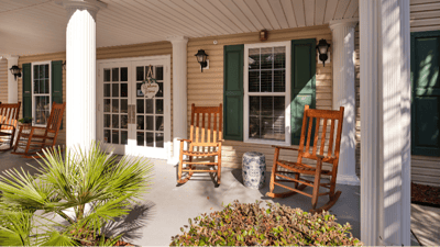 Rocking chairs on a porch of a senior living facility