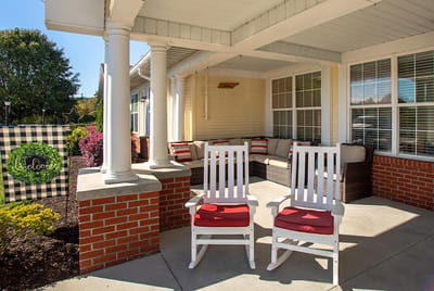 Outdoor seating area with white rocking chairs