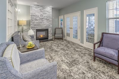 Bright common area with comfortable seating and a fireplace