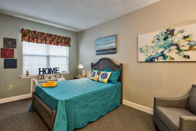 Cozy private resident room with teal accents