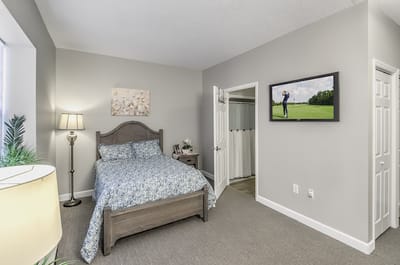 A well-furnished resident room with a single bed and decor