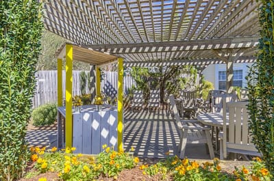 Outdoor seating area with a pergola and flowers