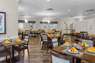 Bright dining room with tables set for meals