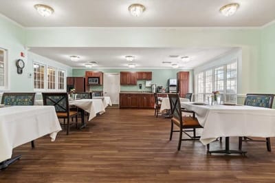 Dining area with tables and a kitchenette
