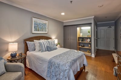 Cozy, well-decorated resident room with a bed and decor