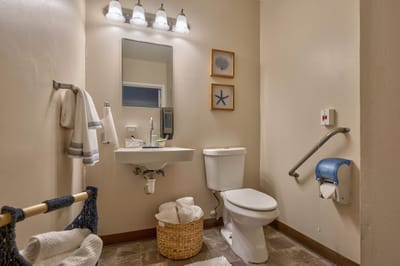 Brightly lit bathroom with accessible features and decor