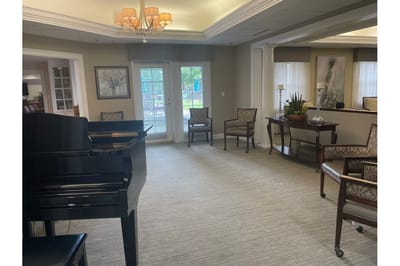 Common area with piano and seating