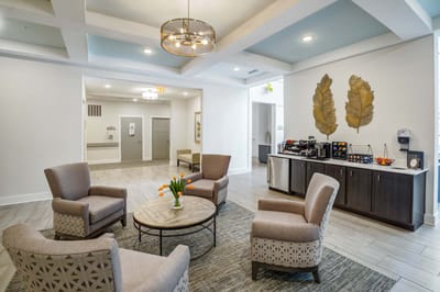 Bright common area with comfortable seating and coffee station
