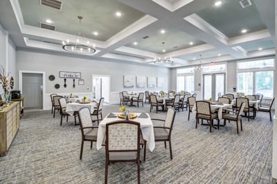 Brightly lit dining room with tables set for meals