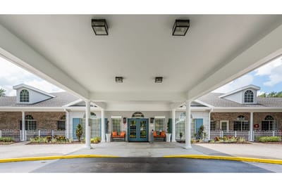 Entrance view of a senior living facility under awning