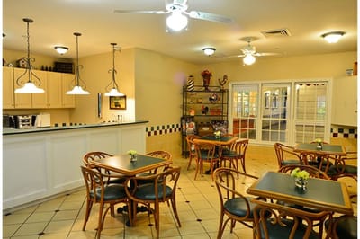 Dining area with tables and chairs in warm lighting