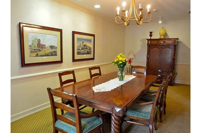 Interior dining area with a wooden table and artwork