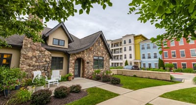 Exterior view of a senior living facility with landscaped gardens