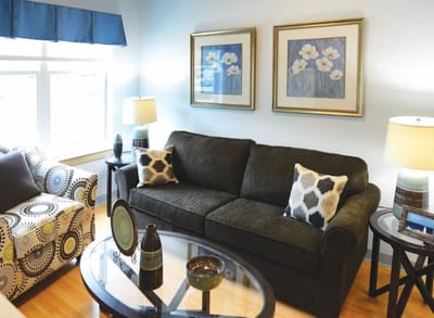 Cozy living area with floral artwork and soft furnishings