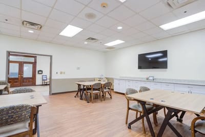 Bright activity room with tables and chairs