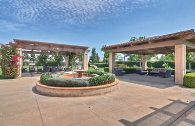 Outdoor patio area with a fountain and seating
