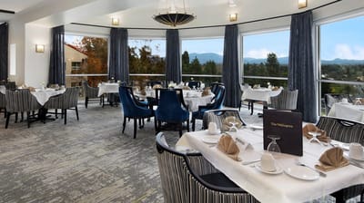 Elegant dining room setup with mountain views