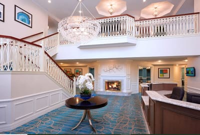 Bright lobby area with chandelier and seating