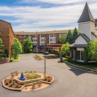 Exterior view of Ascension Living Alexian Village with a landscaped entrance