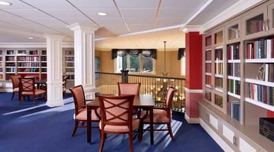 Bright common area with tables and bookshelves