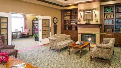 Bright common area with cozy seating near a fireplace