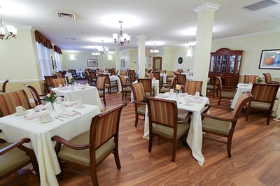 Dining room set up for residents with tables and chairs