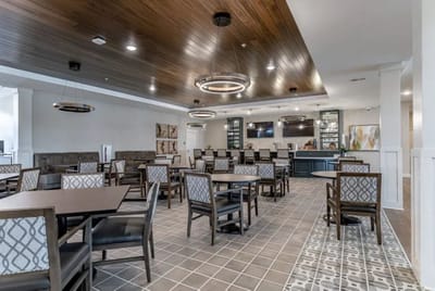 Dining area with tables and chairs in a bright interior