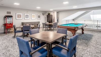 Bright common area with pool table and seating