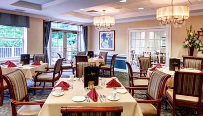 Bright dining room set up for a meal with elegant decor