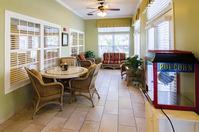 Bright common area with seating and a popcorn machine