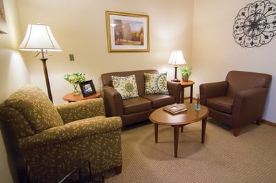 Cozy seating area with two chairs and a sofa