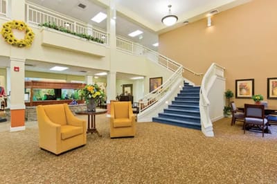 Bright lobby area with seating and a staircase